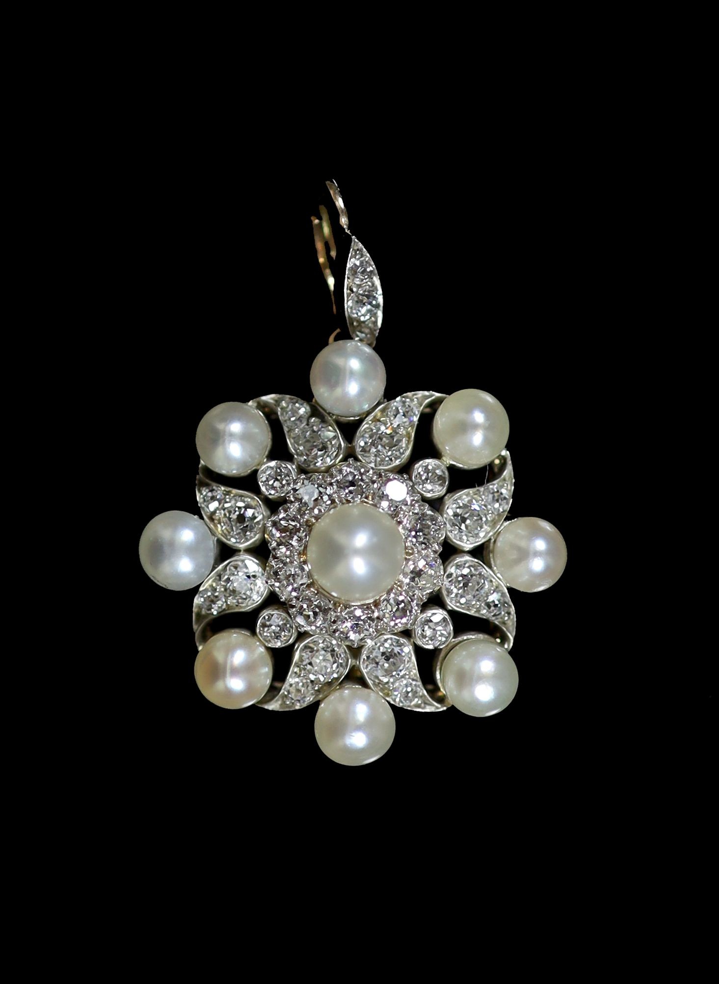An early 20th century gold and silver, pearl and diamond set cluster pendant